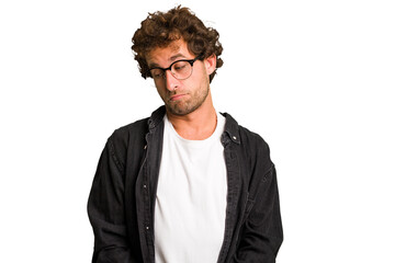 Young curly smart caucasian man cut out isolated shrugs shoulders and open eyes confused.