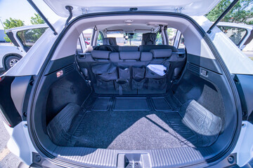 Empty car trunk open view with backseat car organizer with storage pockets. Modern hatchback SUV...