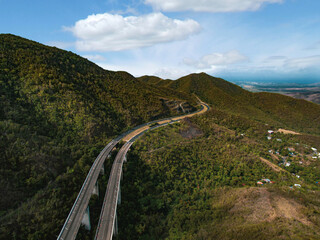 Highway through the central mountain range of Puerto Rico. - 557974317