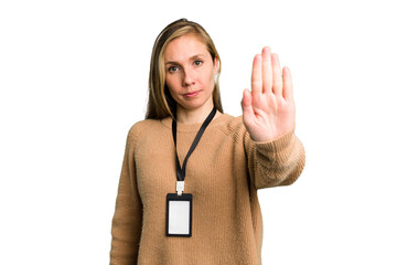 Young caucasian woman with ID card isolated standing with outstretched hand showing stop sign,...