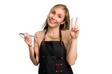 Young caucasian manicurist woman holding an electric file drill isolated joyful and carefree showing a peace symbol with fingers.