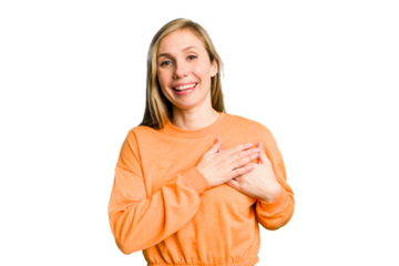 Young caucasian woman cutout isolated has friendly expression, pressing palm to chest. Love concept.