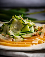 Refreshing and healthy salad with shaved zucchini and sliced melon. Garnished with fresh mint, almonds, and parmesan cheese.