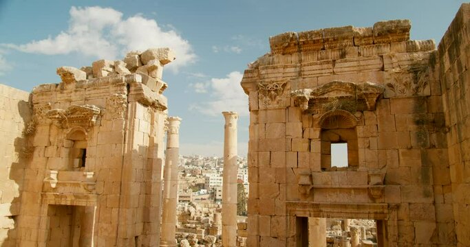 Ancient ruins of Roman styled buildings in Artemis Temple Esplanade Jerash, Jordan. Stone built leftovers with columns during summer travel. Middle East architecture and sighseeing. 4k panning shot