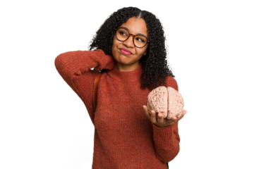 Young student african american woman holding a brain isolated touching back of head, thinking and making a choice.