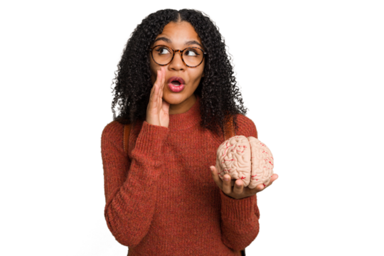 Young student african american woman holding a brain isolated is saying a secret hot braking news and looking aside