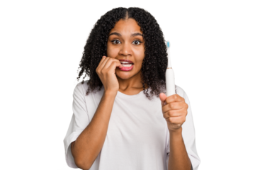 Young african american using a brushing teeth isolated biting fingernails, nervous and very anxious.
