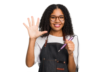 Young african american manicurist woman holding an electric file drill isolated smiling cheerful showing number five with fingers.