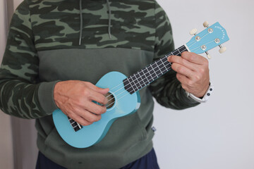 blue Ukuleles man playing 