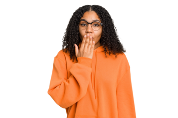 Young african american woman with curly hair cut out isolated shocked, covering mouth with hands, anxious to discover something new.