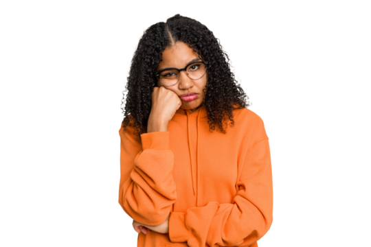 Young african american woman with curly hair cut out isolated who feels sad and pensive, looking at copy space.