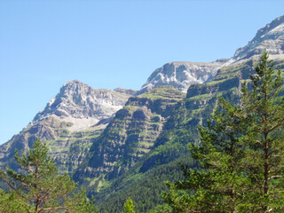 mountainous landscape of the Spanish Pyrenees. lots of green vegetation and high mountains.