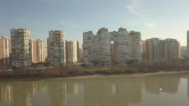 aerial panorama of the world district Novy Gorod (city of Krasnodar) near the Kuban river on a sunny day at the beginning of winter - flat video format (d-cinelike)