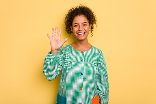 Young Brazilian child education teacher isolated smiling cheerful showing number five with fingers.