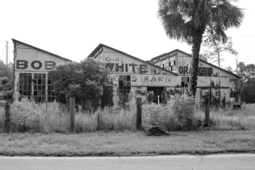 Fototapeten Verlassene Gebäude Black and white front picture of an abandoned and run down orange factory  © Capri