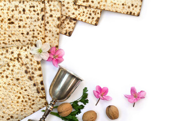 Matzo, wine, white and pink flowers apple tree, nuts for passover celebration on a white background with space for text. Top view, flat lay