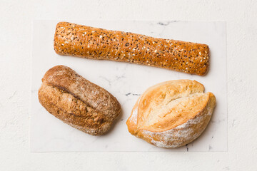 Homemade natural breads. Different kinds of fresh bread as background, top view with copy space