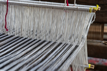 Old hand-weaving vintage wooden loom being used to make fabric