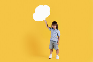 Fototapeta na wymiar Kids opinion matters. Studio shot of cute little boy holding speech bubble and looking at camera, empty space for text