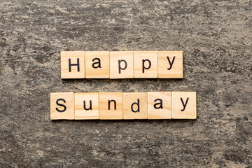 Fototapeta premium Happy sunday word written on wood block. Happy sunday text on cement table for your desing, concept
