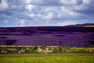 Fototapeta na wymiar Silicon panels of solar batteries against the cloudy sky in the middle of the day.