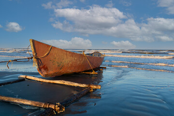 Old fishing boat on the sand 