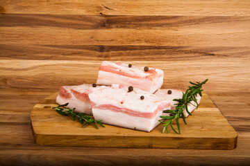 Salo rosemary and pepper on a wooden table.