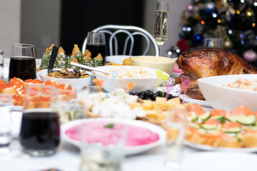 Food. Festive table with salads and appetizers and glasses with drinks. Close-up.