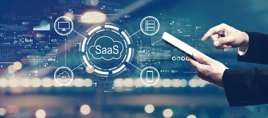 SaaS - software as a service concept with businessman using a tablet computer