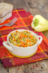 Bowl with hot vegetable stew on a kitchen towel