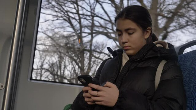 teenage girl with smartphone in tramway, Wroclaw