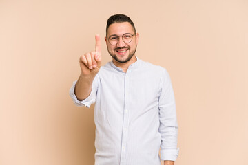 Adult latin man cut out isolated showing number one with finger.