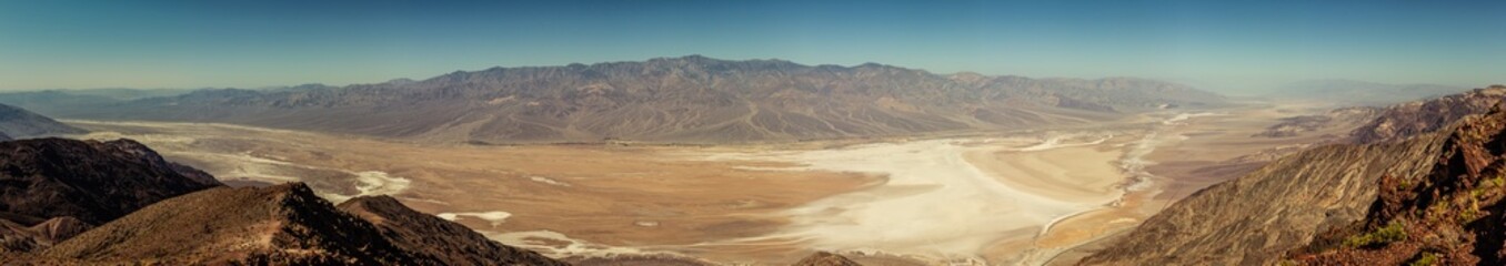 Fototapeta na wymiar Panorama view from hill to desert salt Death Valley in Viewpoint on hill to desert salt valley in america at blue sunny day