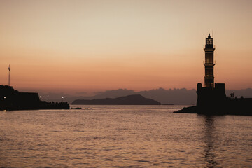 Chania, Greece, view of the old venetian lighthouse in the city harbour at sunset. 