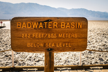 Wooden sign with Badwater Basin 282 feet below sea level in Death Valley in america