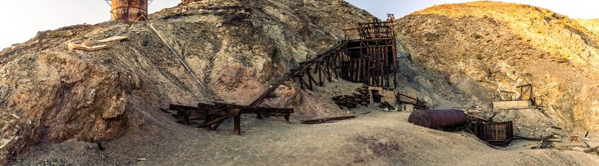 Old rusty wooden unused gold mine in rocky hill in Death Valley national park in america