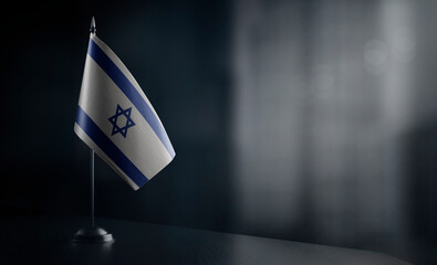 Small national flag of the Israel on a black background