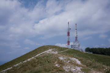 View from Nanos peak or plateau towards the antenna beacons above. Some clouds are visible on the sky. High antennas, 5g radio and tv seen.