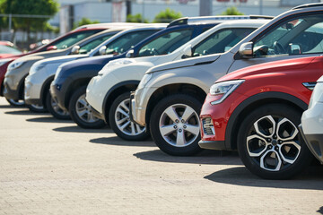 row of used cars. Rental or automobile sale services - obrazy, fototapety, plakaty
