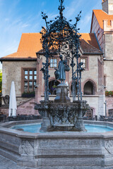 Gaenseliesel fountain with the old town hall in the background, the landmark of Goettingen
