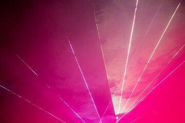 Light show. Laser show. Night club, lights, smoke machine. Pink background