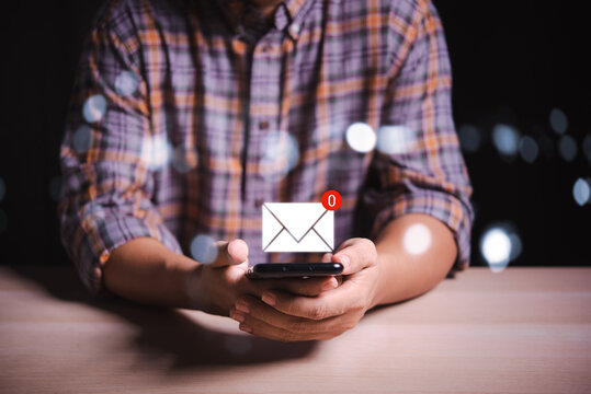 man hand holding smartphone with 0 email sign on screen , no new email contact