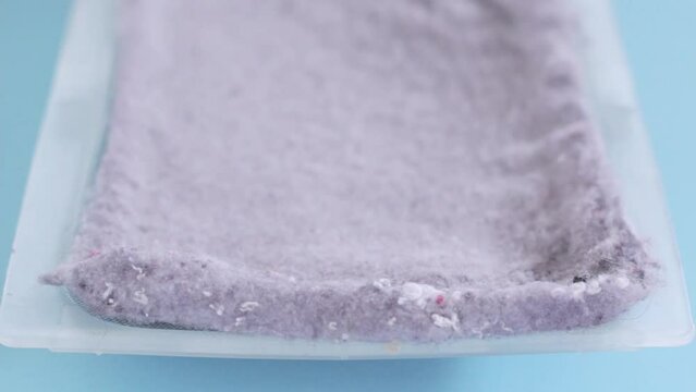 Laundry dryer lint trap on blue