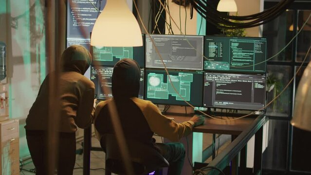 Hackers team trying to break government database server, breaking firewall encryption with malware. Criminals using trojan virus to break network system, making cryptojacking and dos attack.
