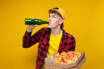 football fan with beer and pizza screaming on yellow background, curly guy eating pizza and...