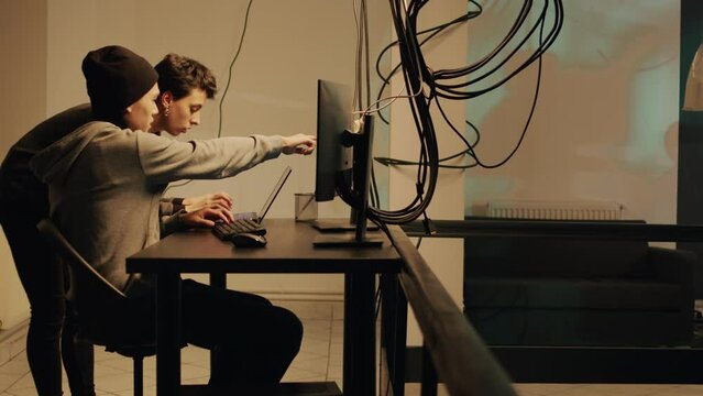 Spies team committing cryptojacking and cyberwarfare, trying to steal passwords and online data. Cyber criminals working on espionage to hack computer system, illegal hacktivism activity.