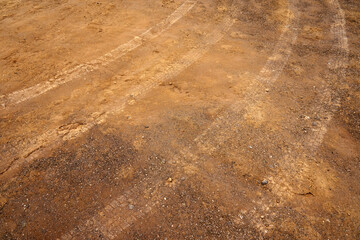 Tire tread marks on the ground as a backdrop.