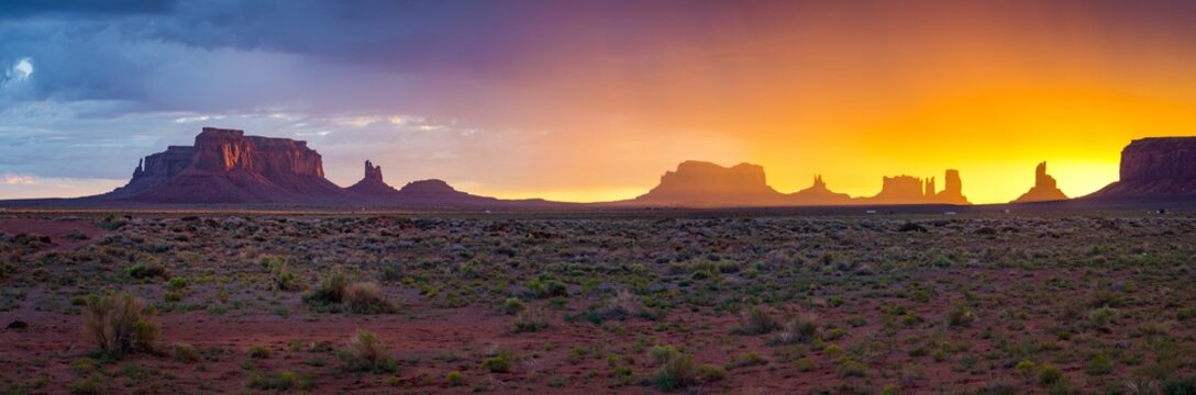 great panorama view of during rainy sunrise in monument valley