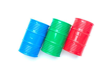 Flatlay picture of oil blue, green and red oil barrels on white background.