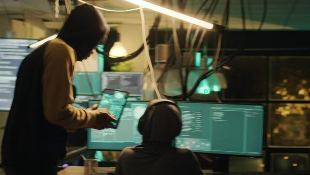 Two people hacking government network to steal valuable data and receive ransom, planting trojan virus to crack software. Team of thieves using cryptojacking concept, hacktivism.